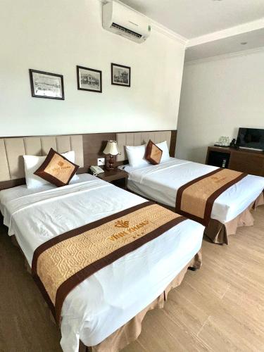 a hotel room with two beds in a room at VĨNH KHANG HẠ LONG HOTEL in Ha Long