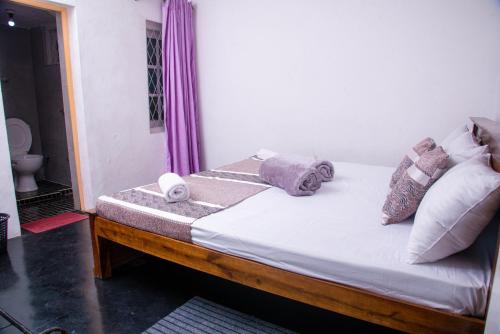 a bed with towels on it in a room at Rose Palace in Nuwara Eliya