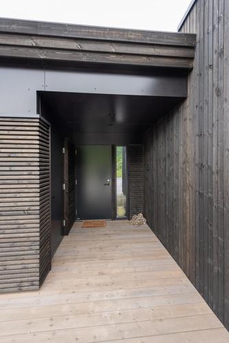 an open hallway of a building with a wooden floor at Hoda Cabin - Luxury lodge with jacuzzi and sauna in Lyngværet