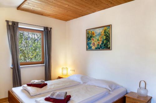 a bed in a room with a window and a bedvisor at Haus Auner Top 4 in Westendorf