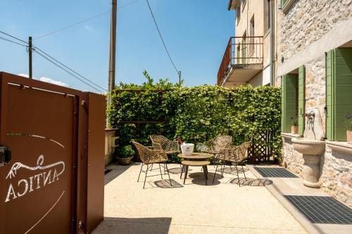 a patio with a table and chairs next to a building at Antica Rinaldo in Valdobbiadene