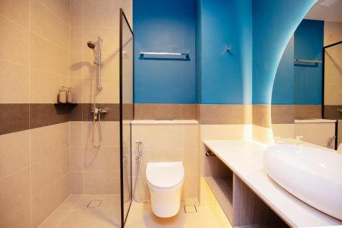 a bathroom with a sink and a toilet and a shower at Coliwoo Hotel Pasir Panjang - CoLiving in Singapore