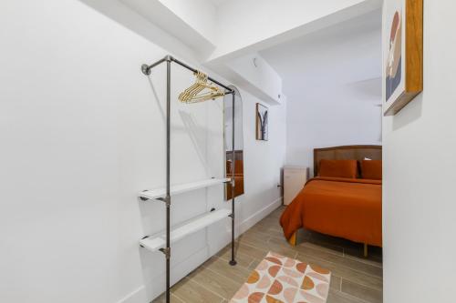 a bedroom with a bed and a glass closet at Tropics Hotel Miami Beach in Miami Beach