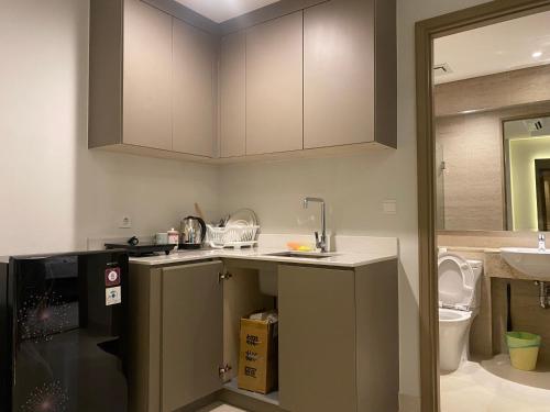 a kitchen with a sink and a counter top at Comfort and Luxury Private Room at Goldcoast PIK in Jakarta