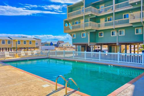 a swimming pool in front of a apartment building at Summer House West Condos in Gulf Shores