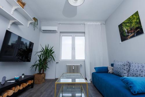a living room with a blue couch and a table at Presidential neighbour retreat in Sofia