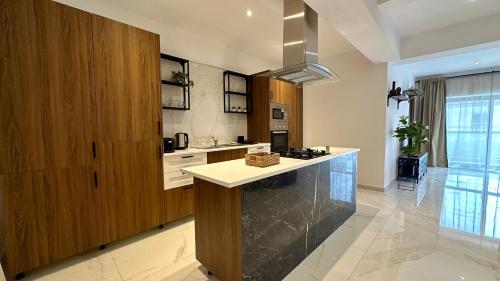 a kitchen with wooden cabinets and a counter top at Pauliz Apartments in San Ġwann