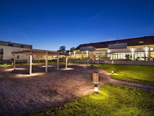 a building with a pavilion in front of it at night at EA Hotel Tereziánský dvůr in Hradec Králové