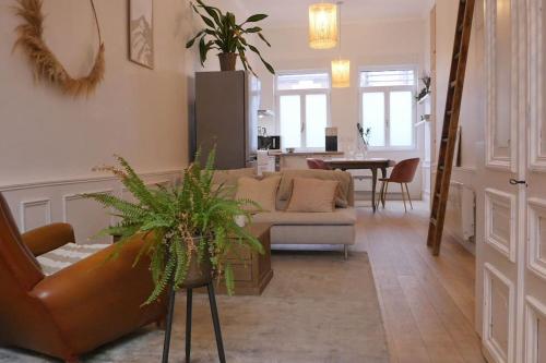 a living room with a couch and a table at OPARADI "Le coconing" en plein cœur du MARCHE DE WAZEMMES in Lille