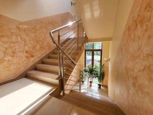 a staircase in a house with a stone wall at Hotel Hesperus in Międzyrzec Podlaski