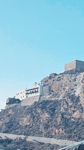 a castle on top of a mountain with a highway at Kontili house in Skiros