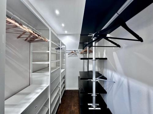 a walk in closet with black and white shelves at La Teresiana apartment in Trieste