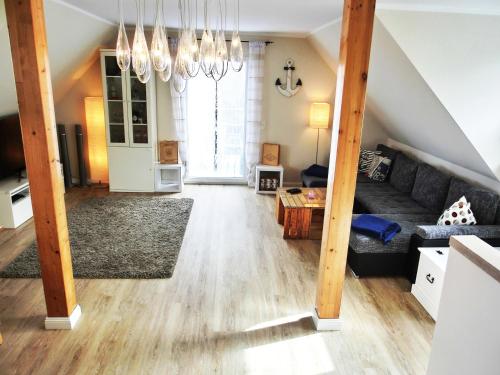 a living room with a couch and a table at Markgrafenheide Ferienhaus MH4 - "Strandhaus" in Markgrafenheide