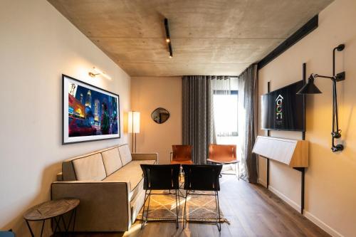 a living room with a couch and a table and chairs at Kaan Casablanca in Casablanca