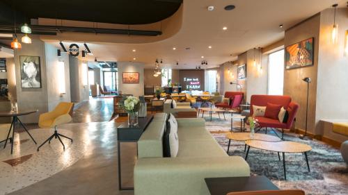 a lobby with couches and chairs and tables at Kaan Casablanca in Casablanca