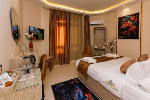 a hotel room with a bed and a desk and a room at Horizon Pyramids View inn in Cairo