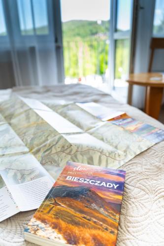 two books sitting on top of a bed at Willa Amelia in Solina
