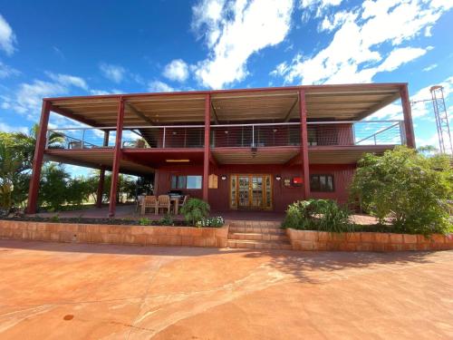 a red house with a balcony on top of it at 13 Skipjack Circle in Exmouth