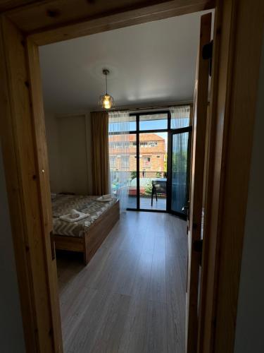 a room with a bed and a large window at Best House in K'obulet'i