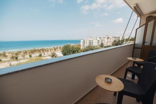 a balcony with chairs and a view of the beach at Voyage Villa in Vlorë