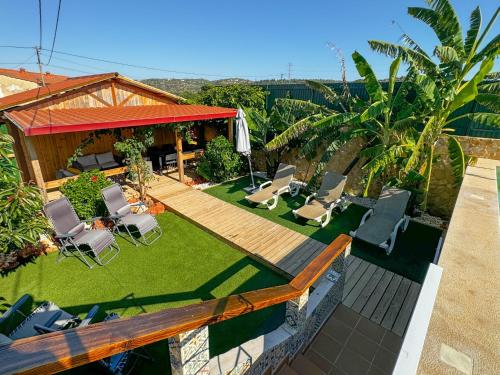 an overhead view of a backyard with chairs and an umbrella at Casa de Aloe in Albufeira