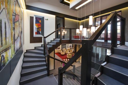 a staircase in a house with art on the walls at Boutique Hotel Villa ZAUBER in Poprad