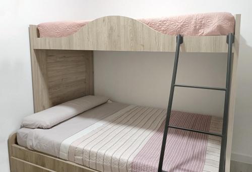 a bunk bed with a ladder in a room at Casa Pastor in Murcia