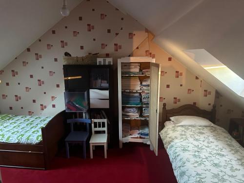 a bedroom with a bed and a book shelf at Maison cosy 600m de la gare de Rambouillet in Rambouillet