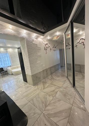 a living room with a wall with drawings on the wall at Kairos apartment in Ventspils