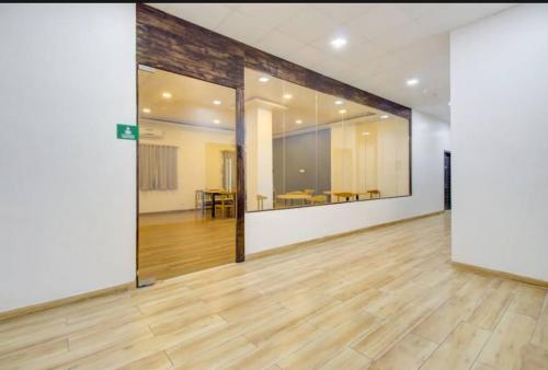 an empty room with a wooden floor and white walls at Parivar Comfort Luxury Rooms in Virār