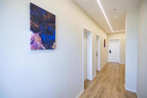 a hallway with white walls and a painting on the wall at Voyage Villa in Vlorë