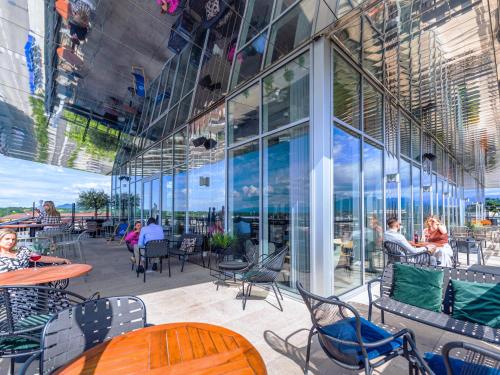 a patio with tables and chairs in a building at Novotel Annemasse Centre - Porte de Genève in Annemasse
