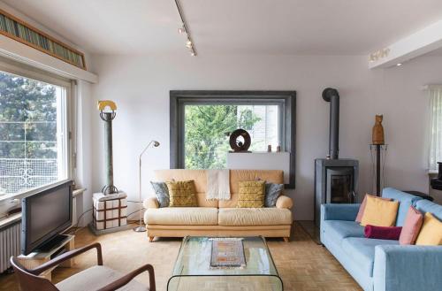 a living room with a couch and a tv at Casa Monte Pace App 3507 in Orselina
