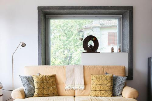 a couch in a living room with a window at Casa Monte Pace App 3507 in Orselina