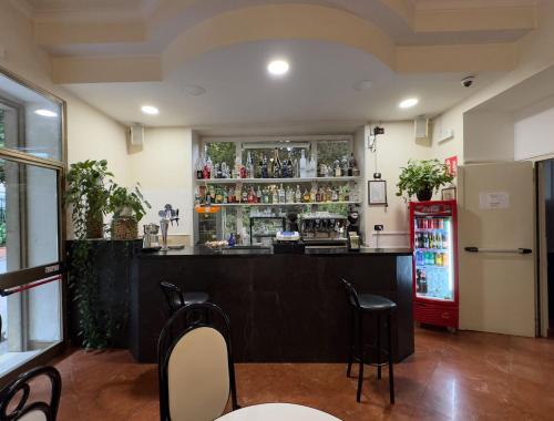 a bar in a restaurant with a red refrigerator at Hotel Villa Robinia in Genzano di Roma