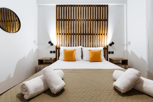 a bedroom with a large bed with orange pillows at Chania Dream House in Chania