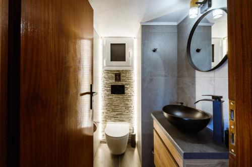 a bathroom with a black sink and a mirror at Chania Dream House in Chania