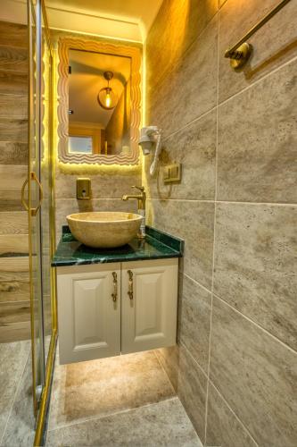 a bathroom with a sink and a mirror at Mahhsen Mansion Oldcity in Istanbul