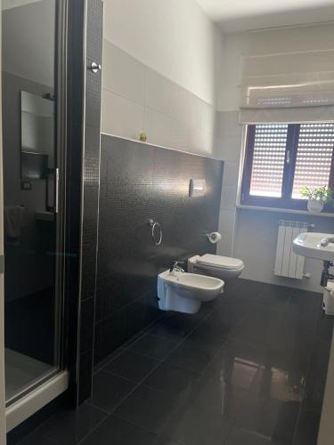 a bathroom with a toilet and a sink and a shower at Sun-kissed seaside retreat: your Pescara getaway in Pescara