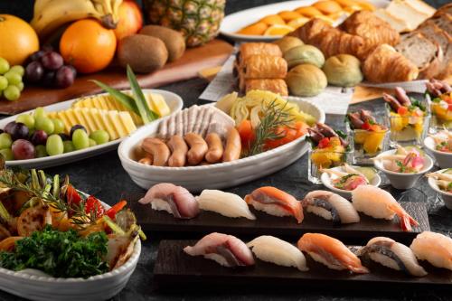 a table with many different types of food on it at HOTEL VISCHIO TOYAMA in Toyama