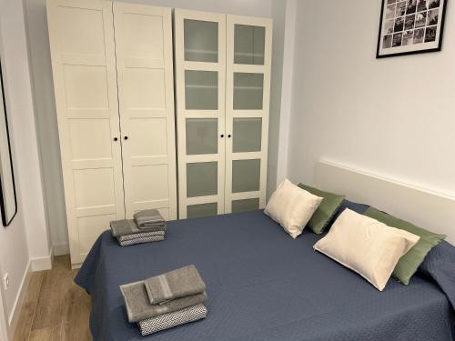 a bedroom with a bed with towels on it at AZCA-Bernabéu Apartments in Madrid