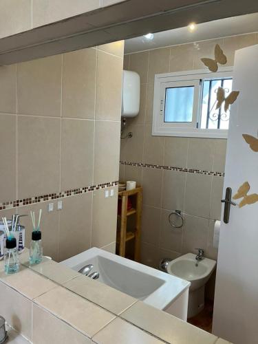 a bathroom with a tub and a sink and a toilet at CasAdri Tenerife in Arona