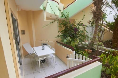 a balcony with a table and chairs on a building at Casa Irma in Santa Maria