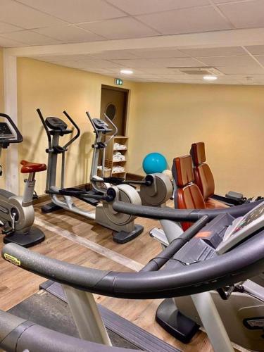 a gym with a bunch of cardio equipment in a room at Studio résidence touristique 3 étoiles in Le Mée-sur-Seine
