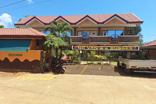 a building with a sign that reads end wars and buses at Citadel Bed and Breakfast in Puerto Princesa City