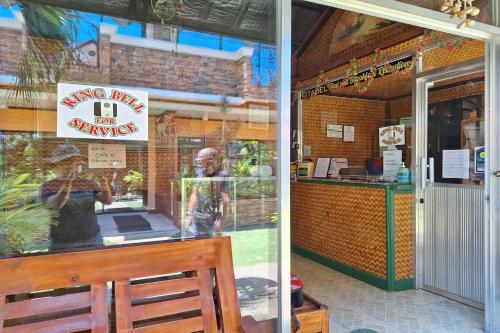 a store front window of a restaurant with a sign at Citadel Bed and Breakfast in Puerto Princesa City