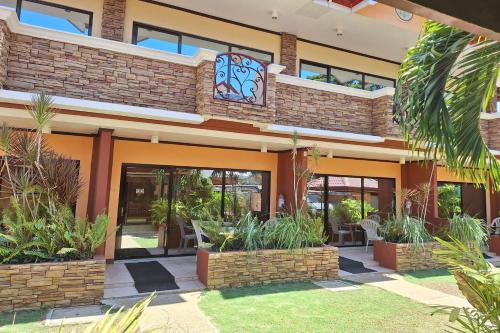 a building with plants in front of it at Citadel Bed and Breakfast in Puerto Princesa City