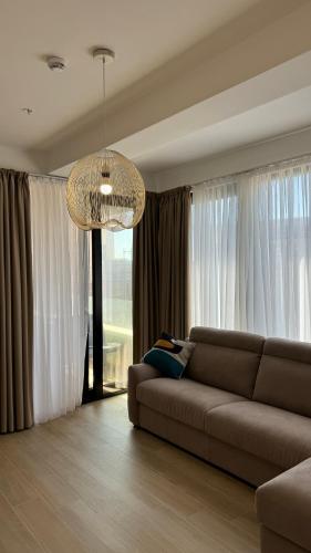 a living room with a couch and a chandelier at Jadran Dream2 in Rafailovici