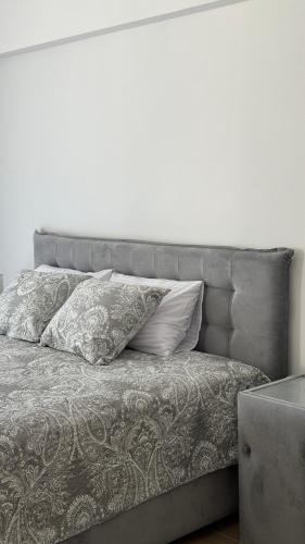a bed with two pillows on top of it at Jadran Dream2 in Rafailovici