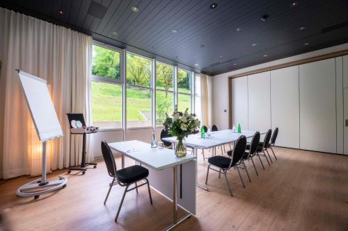 a meeting room with a long table and chairs at Park Hotel Zug in Zug